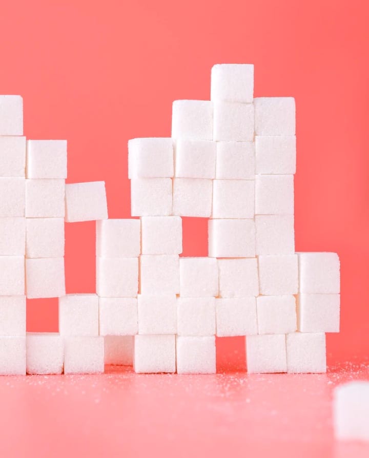 sugar cubes stacked like blocks with pink background