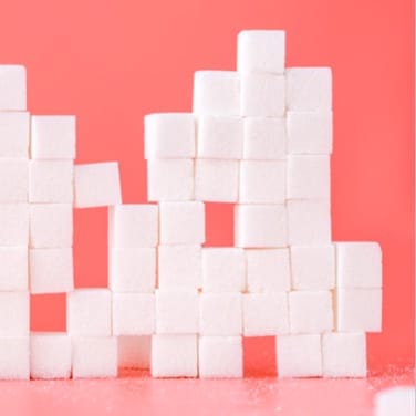 sugar cubes stacked like blocks with pink background